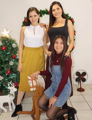 Andrea Meza with her younger sisters